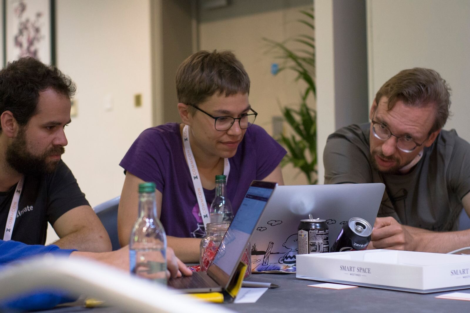 Attendees gathered around laptops at a previous CommCon